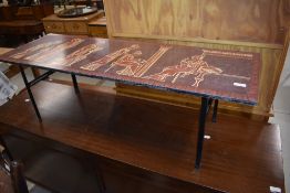 A vintage coffee table in the Piper style, having Greco-Romanesque decoration, approx. 115 x 38cm