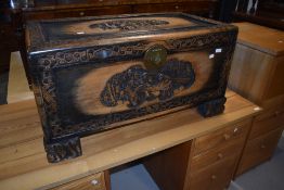 A traditional Oriental carved camphor wood bedding or similar chest, width approx. 90cm