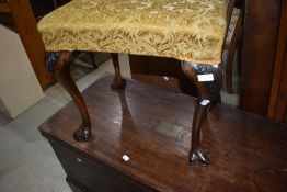 A late 19th or early 20th Century dressing table stool having stuffed seat, cabriole legs and paw