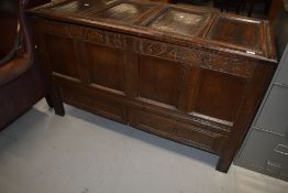 A period oak coffer having monogram and date to frieze, four panels and double drawer base,