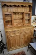 A traditional pine kitchen dresser, having part glazed back, width approx. 130cm