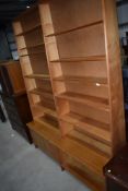 A vintage part pine tapered bookshelf , having cupboard and open shelf to base, height approx 240cm,