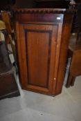 A 19th Century oak corner cupboard, height approx 122cm, with key , currently unlocked but key stuck