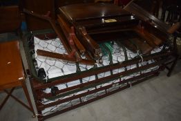 A selection of vintage single bed frames, with bases, labelled for Staples and Co