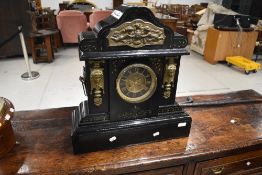A 19th Century and later continental mantel clock, overpainted in black gloss and gilt work,