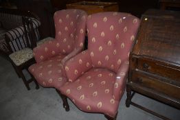 A pair of vintage armchairs in the Queen Anne style having cabriole legs