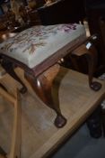 A Queen Anne style oak footstool having woolwork top