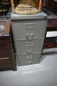 A vintage three drawer metal filing cabinet