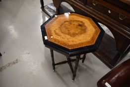 A Victorian ebonised and walnut octagonal occasional table