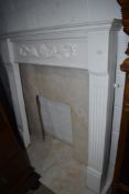 A painted wood fire surround with marble back and hearth