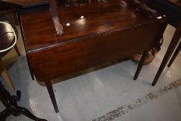 A 19th Century mahogany pembroke style table having frieze drawer and square tapered legs