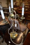 A brass table light having central fitting and three additional branches , candle effect