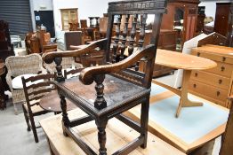 An unsual 19th Century oak and inlaid hall chair having turned spindle back and scroll arms