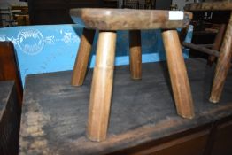 A traditional rustic milking or similar stool on four chunky legs, width approx. 26cm