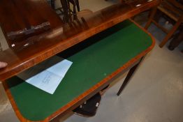 A Regency rosewood and inlaid fold over card table, having tulipwood crossbanding, on square tapered