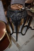 A Chinese hardwood plant stand having rouge marble inset top, height approx. 90cm