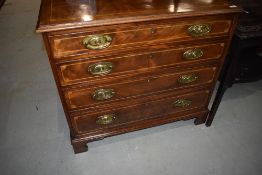 A 19th Century mahogany and satinwood inlaid chest of four long drawers on bracket feet in the