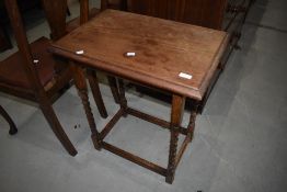 An early 20th Century oak side table having twist legs, width approx. 60cm