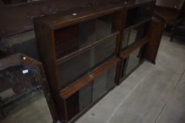 A pair of mid 20th Century dark oak stacking bookcases, minty or similar, each being three tiers ,