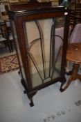 An early 20th Century display cabinet of narrow proportions, having sunburst style glazed front on
