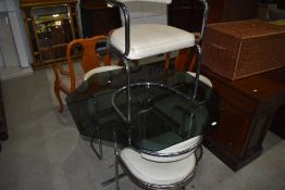 A vintage chrome table and chair set, the table having octagonal glass top, the chairs having