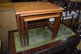 A nest of three teak effect occasional tables