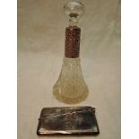 A cut glass scent bottle of conical form having glass stopper and engraved HM silver collar, marks