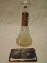 A cut glass scent bottle of conical form having glass stopper and engraved HM silver collar, marks
