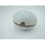 A white metal egg shaped trinket box having white enamelled guilloche decoration with gilt interior,