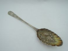 A Georgian silver berry spoon having bright cut decoration and embossed and frilled bowl, London