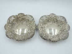 A pair of Edwardian silver trinket dishes having extensive pierced and repousse decoration,