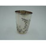 A white metal beaker having Art Nouveau style floral repousse decoration and gilt interior,