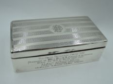 A silver cigarette box of rectangular form having engine turned stripe decoration to lid with