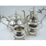 A four piece silver plated tea set of plain circular form having hoof feet