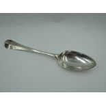 A Georgian dessert spoon of Old English form bearing monogram to front and reverse of terminal,