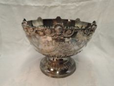 A large Victorian silver punch bowl having moulded mask decoration to rim, with ribbon and scroll