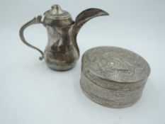 A Middle Eastern white metal Dallah coffee pot of small form bearing Arabic scenes to sides (AF) and