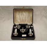 A cased silver five piece cruet set of plain bowl and baluster form, having bakelite liners,