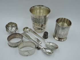 A small selection of HM silver including a beaker having engine turned decoration, two napkin rings,