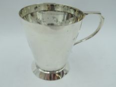 A silver Christening mug of plain tapered form bearing monogram to front, London 1931, Josiah