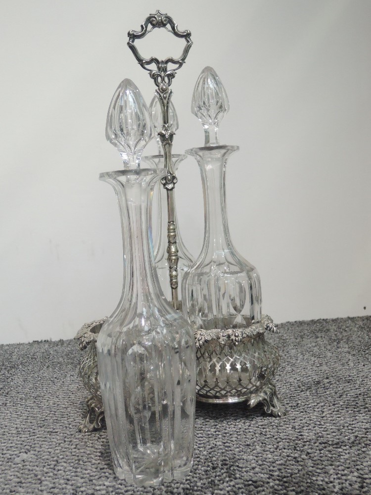 A Victorian silver plated three bottle gallery stand having bacchanalian moulded decoration to rims, - Image 2 of 4