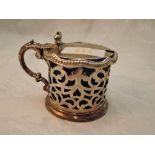 A Victorian silver lidded mustard pot having pierced decoration, moulded bow thumb rest and blue