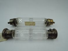 A double ended scent bottle having plated lids in the form of regimental caps, retailed by