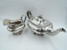 A Dutch silver bachelor teapot and cream jug having moulded bracket pedestal foot, flower finial and