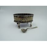 A Victorian silver salt of oval form having pierced and engraved swag decoration, plain cartouche,