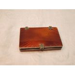 A continental silver card box having tan coloured star burst enamel decoration, gilt interior and