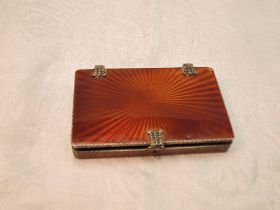 A continental silver card box having tan coloured star burst enamel decoration, gilt interior and