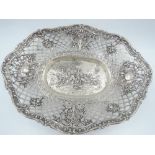 A white metal table basket stamped 800 having repousse scenic decoration to centre with pierced