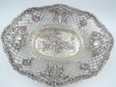 A white metal table basket stamped 800 having repousse scenic decoration to centre with pierced