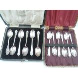 A cased set of six HM silver tea spoons of plain form, a similar cased part set of (5)silver